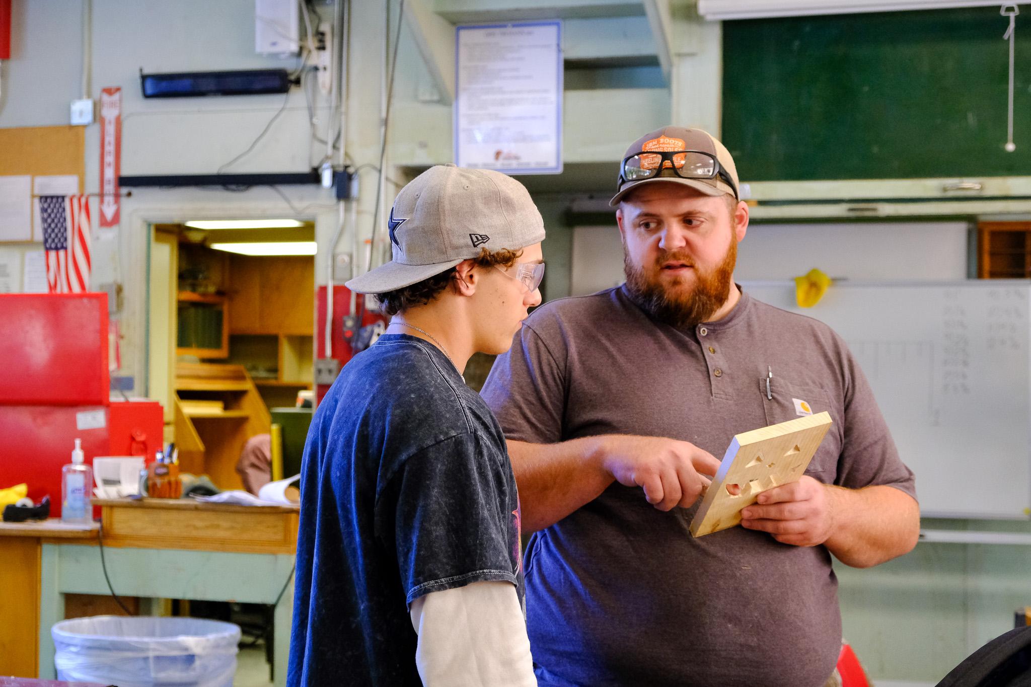 Ag teacher showing student next step in project